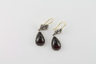 A pair of cabouchon cut garnet drop earrings set diamonds