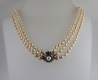 A choker of 3 rows cultured pearls with sterling clasp