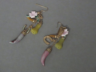 A pair of earrings decorated hardstone fists and other charms