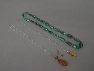 A malachite necklace, a silver necklace hung an amber pendant  with matching earrings and 1 other chain hung an amber pendant