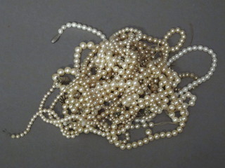 A collection of various simulated pearl necklaces