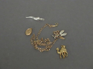 A gilt metal pendant in the form of a cow, a gilt locket, a gilt chain, 2 silver pendants in the form of ballet slippers and 1 other