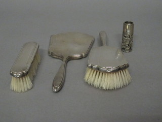A 3 piece Art Deco silver backed dressing table set comprising hand mirror, hair brush and clothes brush, together with a silver  plated bottle mount