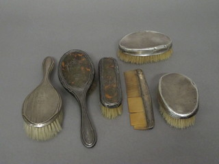 A pair of military silver backed hairbrushes, a silver backed hair  brush, a silver and tortoiseshell backed hairbrush, do. clothes  brush and comb