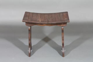 An elm saddle shaped stool, raised on standard end supports 19"