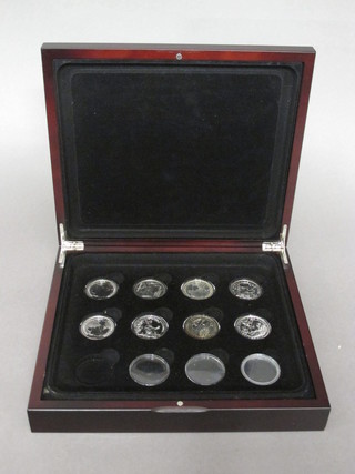 A set of 8 silver proof ?5 coins 2002 - 2009, cased