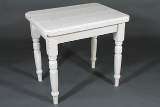 A Victorian white painted lozenge shaped table, raised on turned supports 32"