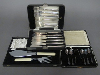 A pair of silver plated fish servers, a set of 6 silver plated fish knives and forks together with 5 silver plated teaspoons and a  pair of tongs, cased