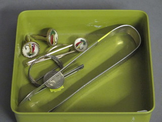 A pair of Georgian bright cut sugar tongs and a small collection of costume jewellery including a pair of gilt cufflinks set fishing  flies