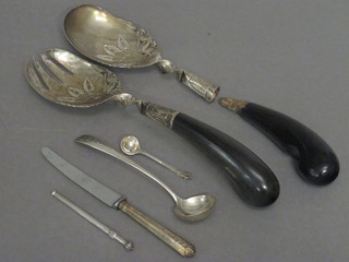 A pair of Eastern white metal salad servers, a silver swizzle  stick, a silver handled knife etc