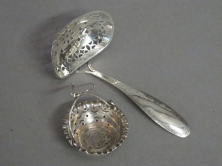 A Continental silver tea strainer and 1 other