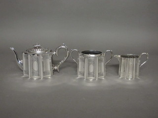 A 3 piece shaped and engraved Britannia metal tea service with teapot, twin handled sugar bowl and milk jug