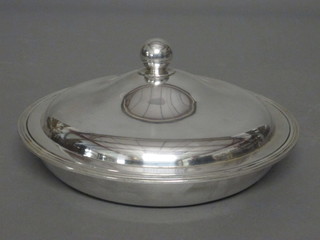 A circular silver plated entree dish and cover