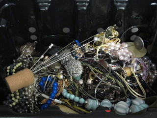 A black plastic tray of costume jewellery