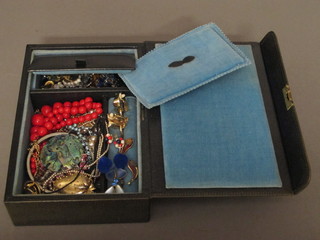 A green box containing costume jewellery