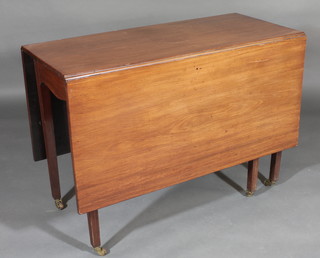 A 19th Century mahogany drop flap gateleg dining table, raised  on square tapering supports ending in brass caps and castors, 42"