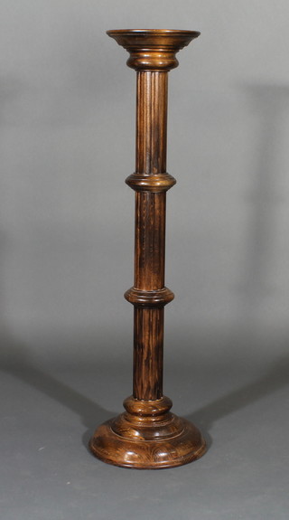 A turned and fluted mahogany pedestal