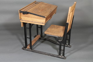 A childs elm and iron school desk
