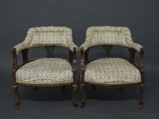 A pair of Edwardian mahogany tub back chairs with vase shaped  slat backs and upholstered seats, raised on cabriole supports