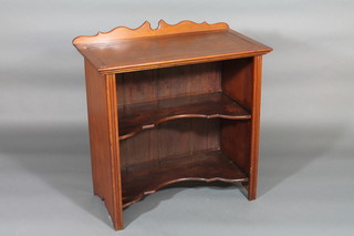 An Edwardian student's walnut writing table/bookcase with raised back and inset writing surface, the base fitted 2 shelves  30"