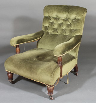 A Victorian oak framed Howard style armchair upholstered in  green material