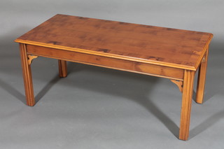A Georgian style rectangular yew coffee table with crossbanded top, raised on square supports 42"