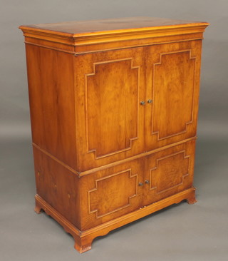 A Georgian style walnut cabinet enclosed by panelled doors, 35"