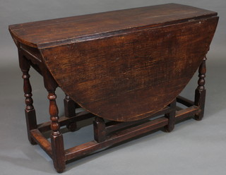 An 18th Century oak gateleg dining table, raised on turned and block supports 48"