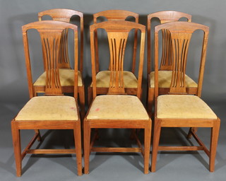 A set of 6 Edwardian mahogany high back dining chairs with upholstered drop in seats, raised on square tapering supports with  H framed stretchers