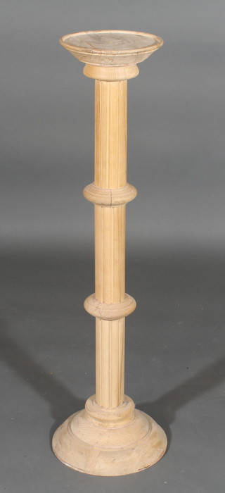 A bleached mahogany torchere on turned and fluted column