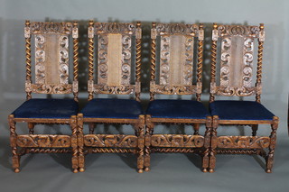 A set of 4 carved oak Carolean high back dining chairs with woven cane seats and backs, raised on spiral turned and block  supports