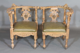 A handsome pair of Italian bleached walnut slat back corner chairs, heavily carved throughout and with upholstered drop in  seats, raised on turned supports  ILLUSTRATED