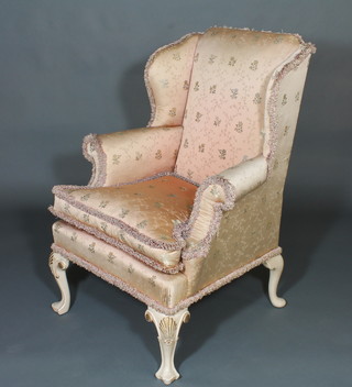 A Georgian style winged armchair upholstered in pink material,  raised on cabriole supports