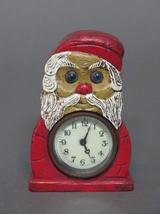 A novelty mantel clock in the form of Father Christmas with  moving eye movement, contained in an iron case with enamelled  dial and Arabic numerals