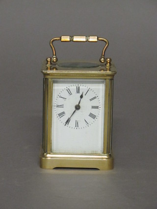 A 19th Century French 8 day carriage clock with enamelled dial  and Roman numerals contained in a gilt metal case