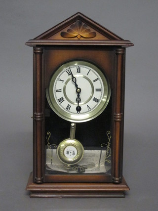 A 31 day wall clock with paper dial and Roman numerals  contained in a walnut case