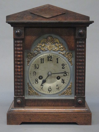 An 8 day striking bracket clock with silvered dial, Arabic numerals and gilt metal spandrels, contained in an oak case