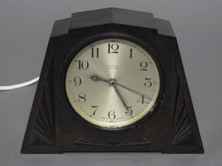 An Art Deco electric mantel clock with silvered dial and Arabic numerals contained in a black Bakelite case by Ingasol