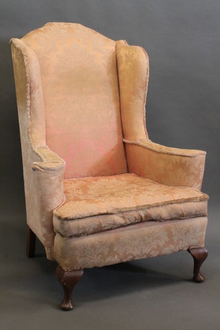 A pair of Georgian style mahogany framed wing back armchairs upholstered in pink material raised on cabriole supports