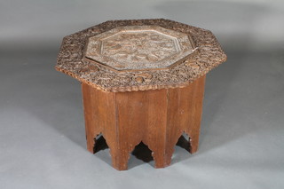 An octagonal carved hardwood folding table inset a pierced  copper tray 31"