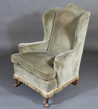 A Georgian style mahogany wing armchair upholstered in green Dralon