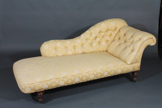 A Victorian mahogany chaise longue upholstered in buttoned back yellow material