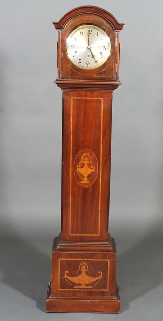 A 1930's chiming Granddaughter clock with silvered dial and Arabic numerals contained in an arch shaped inlaid mahogany  case 53"
