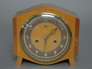 A 1950's Smiths chiming mantel clock with gilt dial and Arabic numerals contained in a walnut arch shaped case