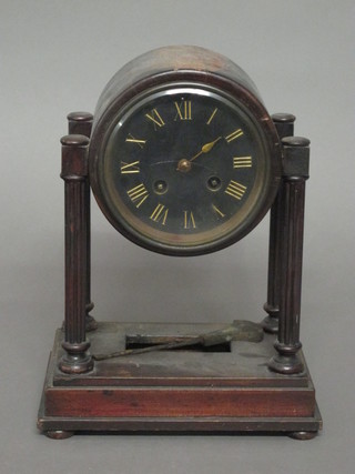 A Victorian 8 day striking Portico clock with slate dial and Roman numerals, contained in a mahogany case supported by  columns