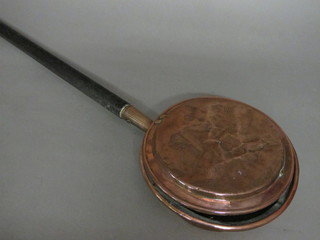 An 18th copper warming pan with turned ebony handle