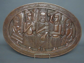 An African carved oval wooden plaque 30"