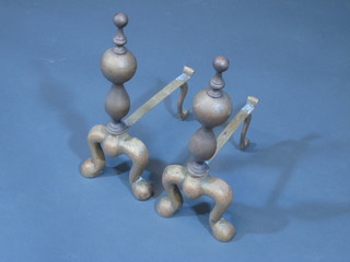 A pair of Dutch style brass fire dogs