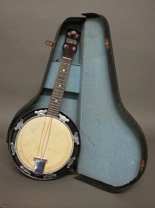 A 4 stringed banjo, the head marked Melody-Uke complete with  fibre carrying case