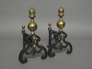 A pair of Victorian iron and brass fire dogs